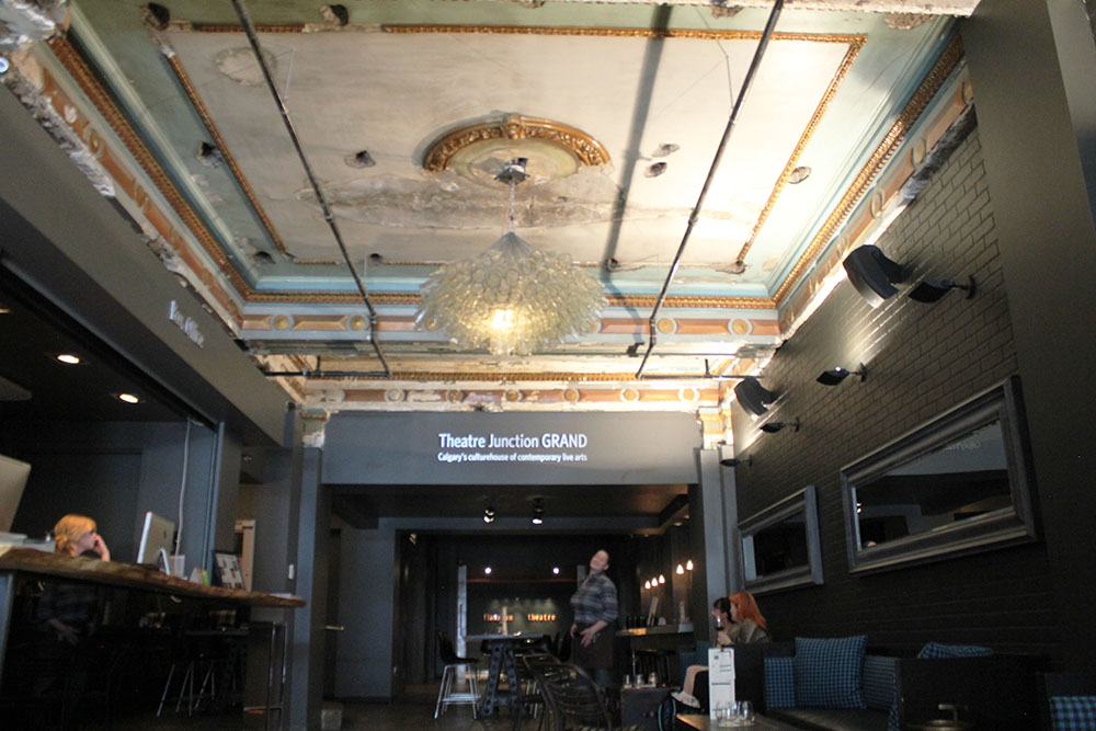 Theatre Junction’s renovation saw a number of old features returned, such as the original ceiling from 1912. The ceiling still has scars from its many prior renovations, including a number of holes used by Odeon to install a cork board ceiling, which completely covered its art deco style. The chandeliers were made by Montreal artist Eric Sauvé using broken wine bottles.