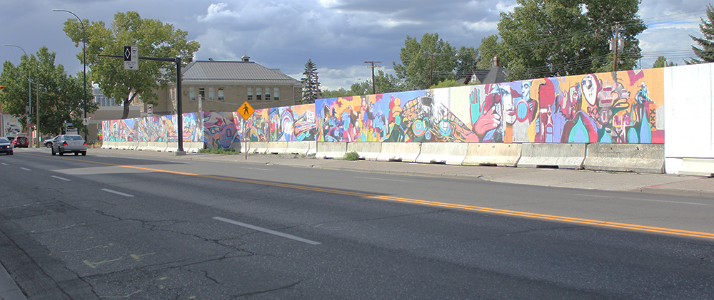 The longest stretch of mural is on 9 Avenue S.E. It continues around the corner on the hoarding boards on 9 Street S.E.