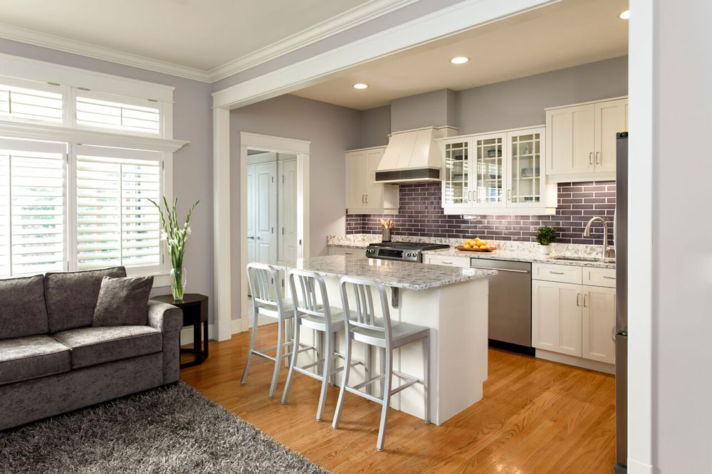 The only space-planning change to the kitchen was making the island top bigger so that it would overhang and create a space for seating. Brackets under the countertop help make it structurally sound.