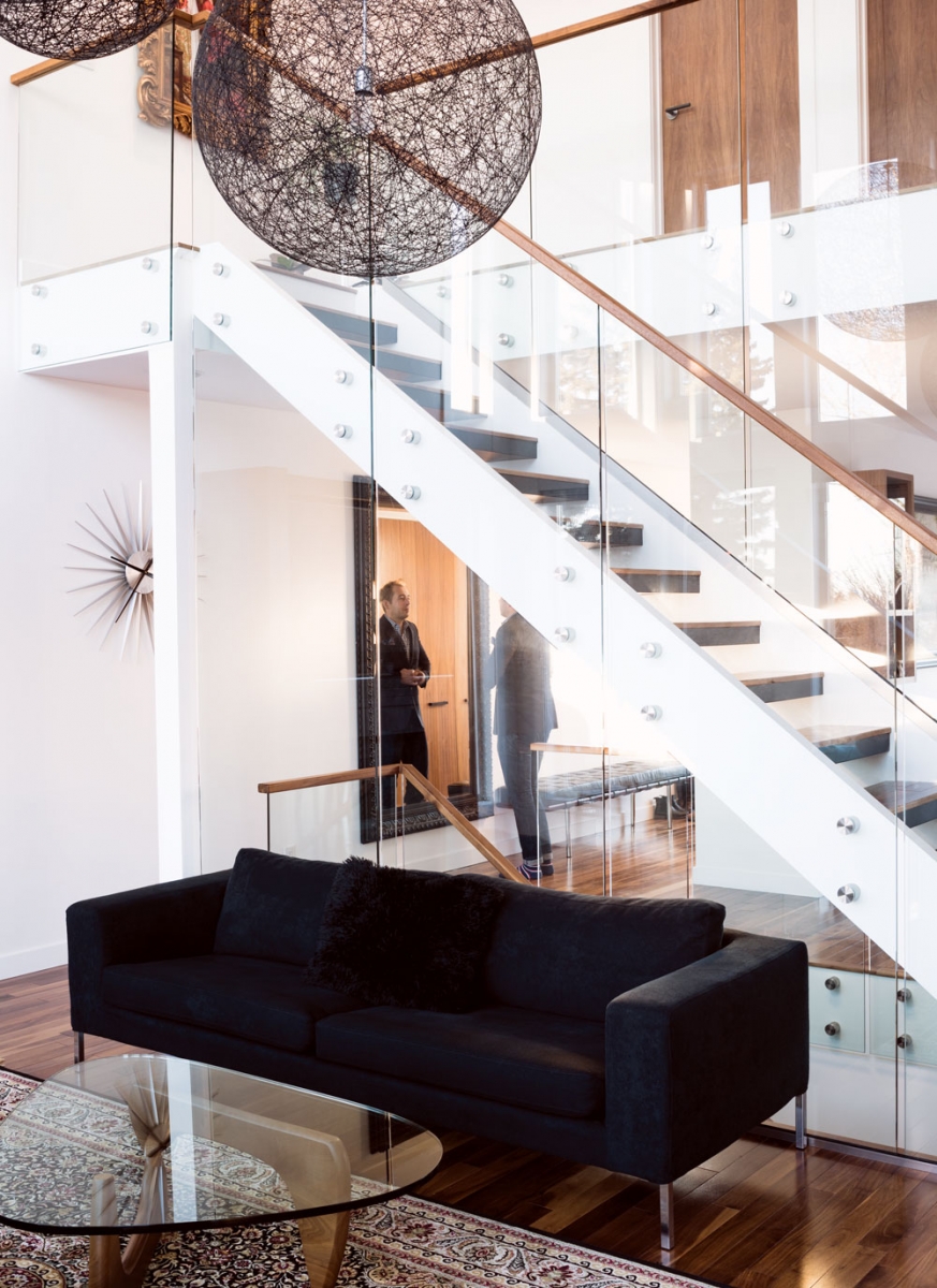 The home’s open floor plan is punctuated by a glass-walled staircase.