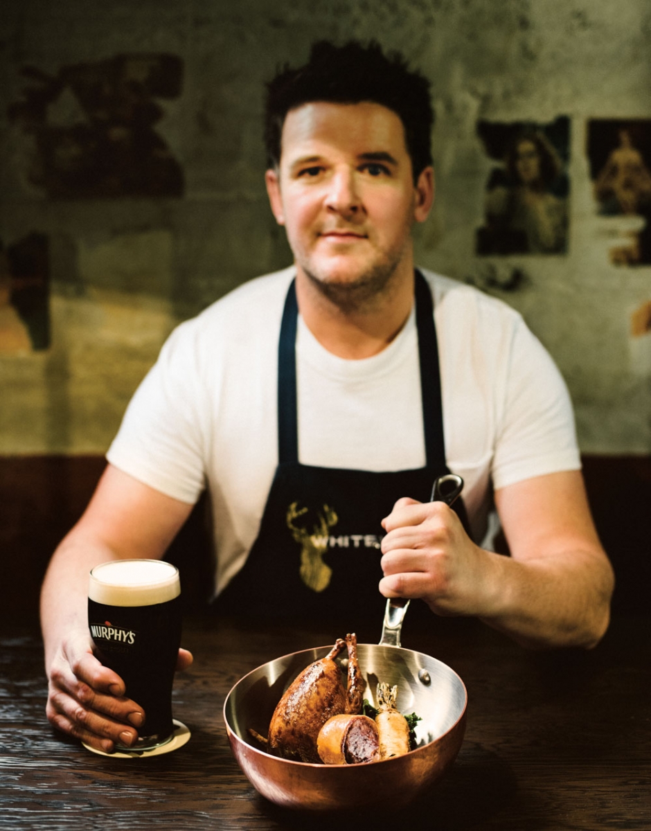 Chef Neil McCue with roasted pigeon and sausage roll.