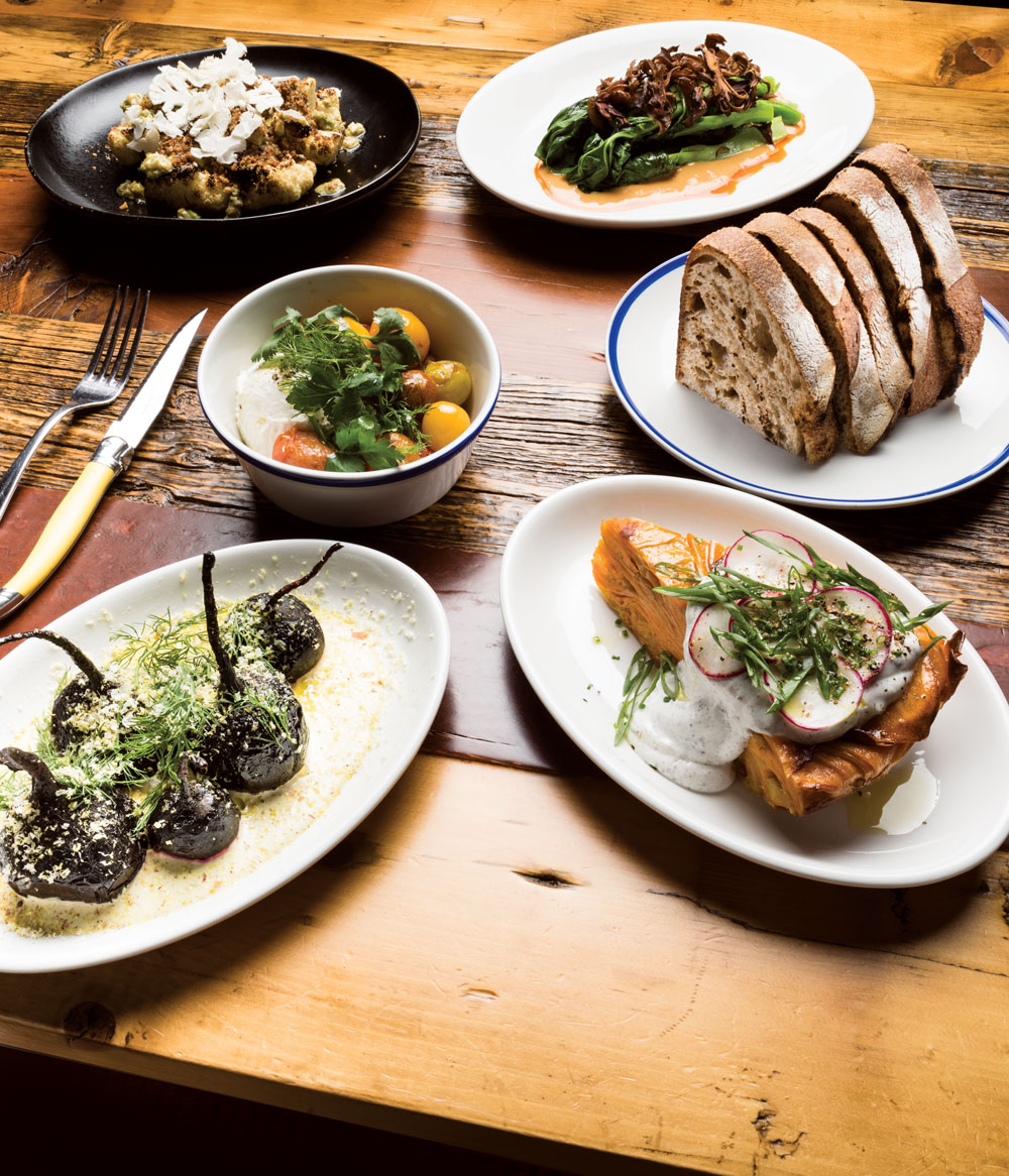 Clockwise from top left: Grilled cauliflower bagna cauda with garlic bread crumb; sautéed gai lan; Sidewalk Citizen sourdough toast; yam tortilla with scallion, sumac, nigella, and sour cream; whole roasted beets with pistachio crema and fresh dill; tomatoes with fresh herbs and whipped feta.