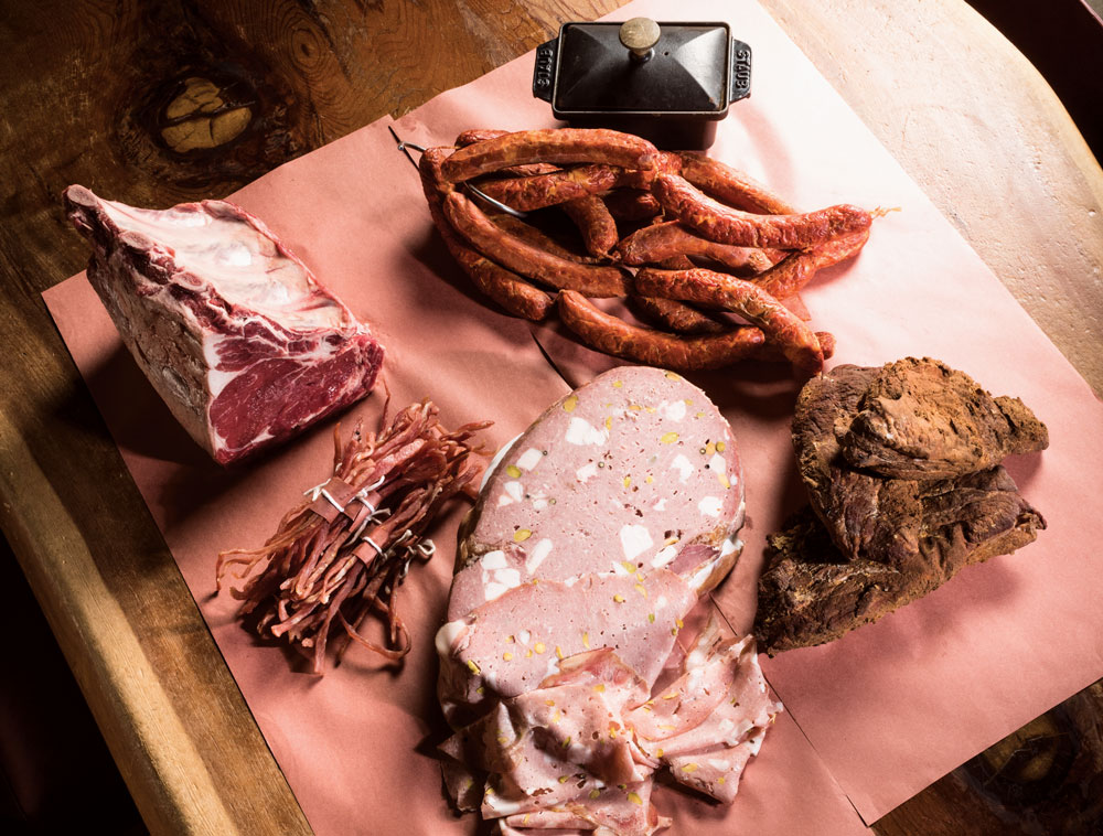 Clockwise from above: Charbar’s short loin of ultra-dry-aged beef and Charcut’s pig-head mortadella, tasso ham, lonzino and chorizo sausage.