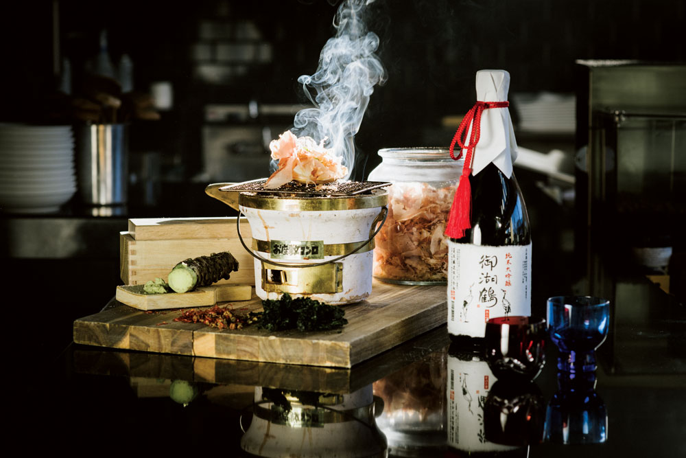 Scallop isoyaki, grilled tableside, with sake.