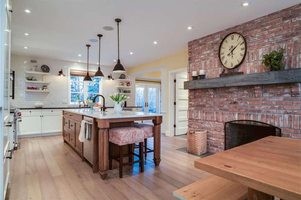 The kitchen has a Carrara marble island and black leathered granite countertops. 