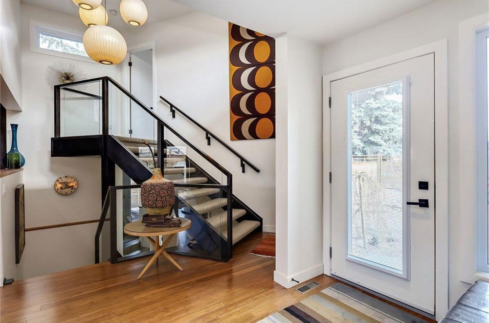 The front yard has a landscaped patio and the sunny foyer opens onto the living room.