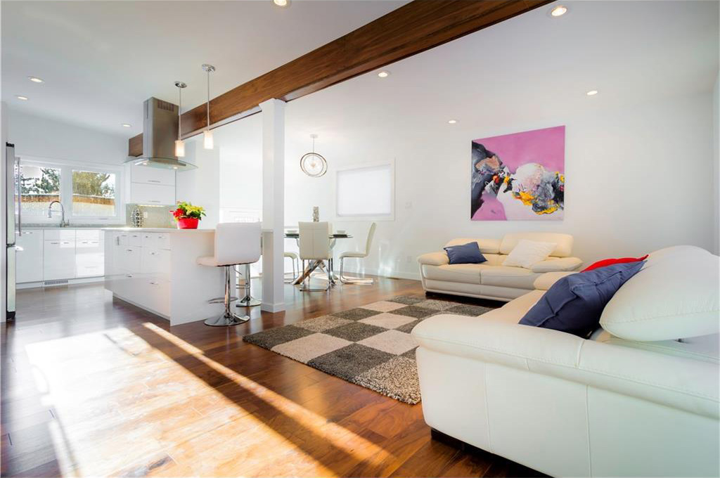 The open concept living room has new hardwood floors.